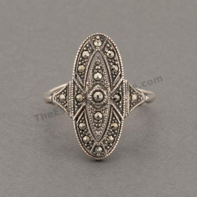 Sale Photo Thumbnail #6: Art Deco-inspired sterling silver ring with an elongated oval openwork face set with numerous marcasite-style accents. Decorative milgrain edging and geometric details continue onto the shoulders. Marked 925; approximate ring size 6.5 and estimated gross 