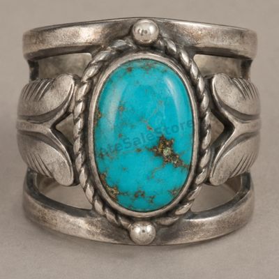 Sale Photo Thumbnail #12: Wide sterling silver ring featuring an oval turquoise-style cabochon with natural-looking matrix, framed by twisted-rope and leaf details. Openwork shoulders and an oxidized finish emphasize the Southwestern design. Marked Sterling; approximate ring size 