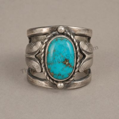 Sale Photo Thumbnail #11: Wide sterling silver ring featuring an oval turquoise-style cabochon with natural-looking matrix, framed by twisted-rope and leaf details. Openwork shoulders and an oxidized finish emphasize the Southwestern design. Marked Sterling; approximate ring size 