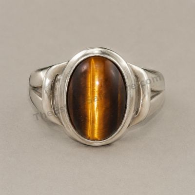 Sale Photo Thumbnail #15: Heavy sterling silver men's ring set with a large oval tiger's-eye-style cabochon displaying a strong golden chatoyant band. Smooth bezel and simple split-shoulder design. Marked 925; approximate ring size 11 and estimated gross weight 14.8 grams. Light s