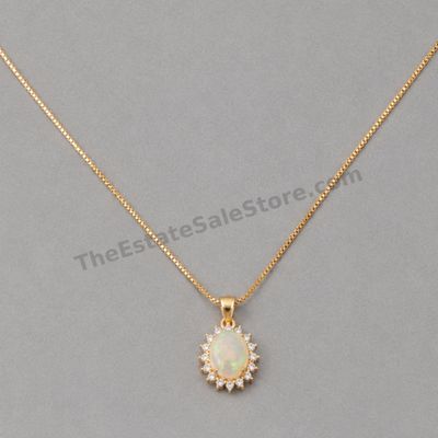 Sale Photo Thumbnail #22: Yellow-gold pendant featuring an oval opal-style center with visible multicolor play-of-color, surrounded by a halo of small diamond-style accent stones. Includes an 18-inch box chain with spring-ring clasp. Marked 14K; estimated combined gross weight 4.6