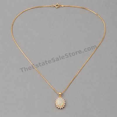 Sale Photo Thumbnail #21: Yellow-gold pendant featuring an oval opal-style center with visible multicolor play-of-color, surrounded by a halo of small diamond-style accent stones. Includes an 18-inch box chain with spring-ring clasp. Marked 14K; estimated combined gross weight 4.6