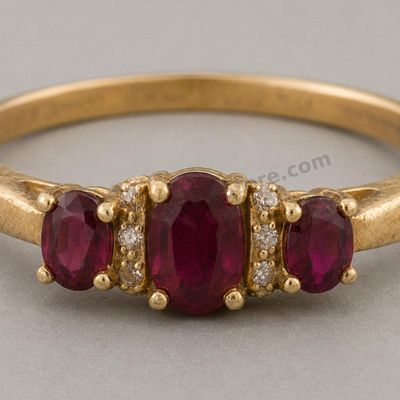 Sale Photo Thumbnail #36: Yellow-gold ring set with three oval ruby-style stones in a graduated prong setting, accented by small diamond-style stones along the shoulders. Marked 14K; approximate ring size 7.5 and estimated gross weight 4.9 grams. The band shows fine scratches and 