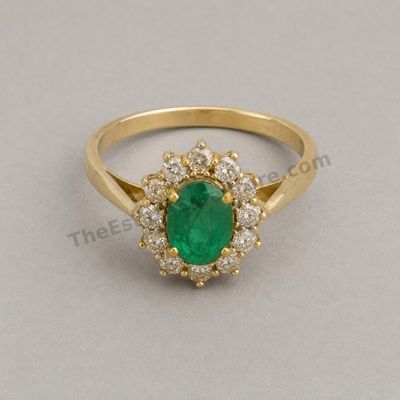 Sale Photo Thumbnail #37: Rich yellow-gold cluster ring centered by an oval emerald-style stone surrounded by round diamond-style accents. Raised gallery and split shoulders create a substantial presentation. Marked 18K; approximate ring size 6.75 and estimated gross weight 6.8 gr