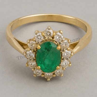 Sale Photo Thumbnail #38: Rich yellow-gold cluster ring centered by an oval emerald-style stone surrounded by round diamond-style accents. Raised gallery and split shoulders create a substantial presentation. Marked 18K; approximate ring size 6.75 and estimated gross weight 6.8 gr