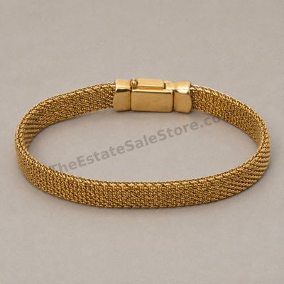 Sale Photo Thumbnail #49: Wide flexible yellow-gold mesh bracelet with polished end caps and concealed box clasp. Marked 750 and Italy; approximate wearable length 7.25 inches and estimated gross weight 24.2 grams. Mesh is intact with light handling marks and mild clasp wear.
