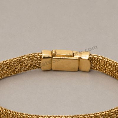 Sale Photo Thumbnail #50: Wide flexible yellow-gold mesh bracelet with polished end caps and concealed box clasp. Marked 750 and Italy; approximate wearable length 7.25 inches and estimated gross weight 24.2 grams. Mesh is intact with light handling marks and mild clasp wear.