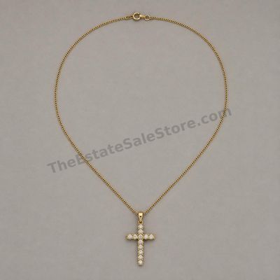 Sale Photo Thumbnail #51: Yellow-gold cross pendant set with eleven round diamond-style stones and suspended from an 18-inch fine curb chain. Pendant and chain marked 14K; estimated combined gross weight 4.8 grams. Light scratches are visible on the reverse of the pendant.