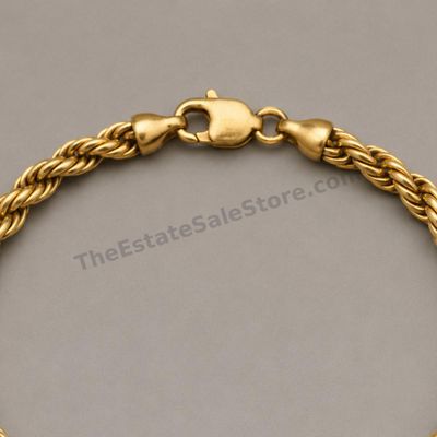Sale Photo Thumbnail #58: Substantial yellow-gold rope-link bracelet finished with a lobster clasp. Approximate wearable length 8 inches and width 6 mm; marked 14K; estimated gross weight 16.9 grams. Moderate surface scuffs and slightly darkened recesses provide a naturally worn a