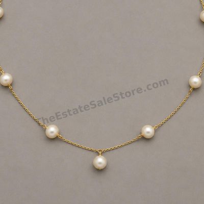 Sale Photo Thumbnail #62: Elegant yellow-gold station necklace featuring seven evenly spaced cultured pearl-style beads on a fine 20-inch chain. Marked 750; estimated gross weight 9.2 grams. Pearls display creamy luster with small natural-looking surface blemishes; clasp has minor
