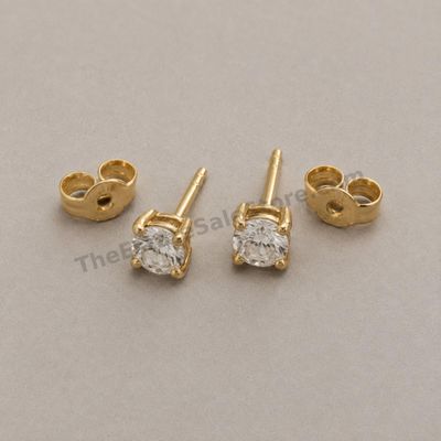 Sale Photo Thumbnail #70: Matched pair of classic yellow-gold stud earrings, each set with one round brilliant diamond-style stone in a four-prong basket. Friction backs included. Marked 18K; estimated combined gross weight 2.2 grams. Very good cosmetic condition with light post w