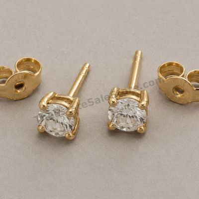 Sale Photo Thumbnail #69: Matched pair of classic yellow-gold stud earrings, each set with one round brilliant diamond-style stone in a four-prong basket. Friction backs included. Marked 18K; estimated combined gross weight 2.2 grams. Very good cosmetic condition with light post w