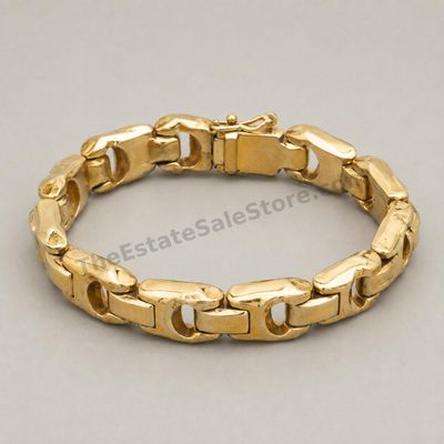 Sale Photo Thumbnail #71: Bold yellow-gold panther-link bracelet with broad articulated links, concealed box clasp, and safety catch. Marked 14K; approximate wearable length 7.5 inches and estimated gross weight 28.6 grams. Visible surface scratches and slight finish wear are cons