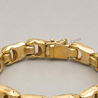 Sale Photo Thumbnail #72: Bold yellow-gold panther-link bracelet with broad articulated links, concealed box clasp, and safety catch. Marked 14K; approximate wearable length 7.5 inches and estimated gross weight 28.6 grams. Visible surface scratches and slight finish wear are cons