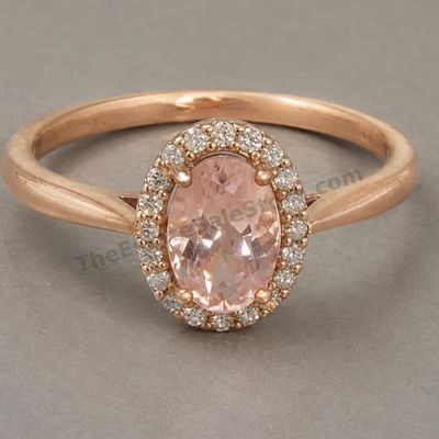 Sale Photo Thumbnail #74: Rose-gold ring centered by an oval peach-pink morganite-style stone surrounded by a halo of small diamond-style accents. Marked 14K; approximate ring size 7.25 and estimated gross weight 4.6 grams. Light surface wear with small scratches at the bottom of 