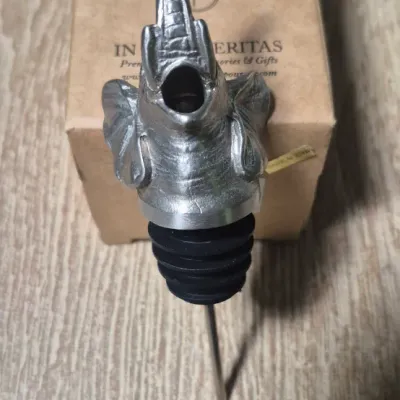 Sale Photo Thumbnail #313: The Elephant Head Pourer/Aerator/Stopper is a unique and fun addition to any bar collection. Made of metal with a silver color, this head-shaped pourer features an elephant design that adds a charming touch to your kitchen or home decor. Perfect for aerat
