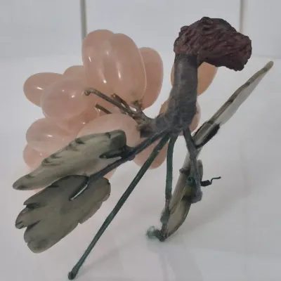 Sale Photo Thumbnail #277: This is a realistically carved rose jade bunch of grapes with darker jade carved leaves. The stem network is wire wrapped with blue satin cord and the end where it would have been cut from the vine is faux wood. The leaves and grapes have some flexibility