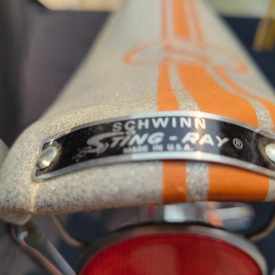 Sale Photo Thumbnail #13: Schwinn Sting-Ray Orange Krate with 5-speed Stik-Shift, springer front fork, high-rise handlebars, orange glitter grips, tall sissy bar, 1990's reproduction schwinn krate banana seat, original white letter slik rear tire, rear reflector, a PAIR of Schwinn