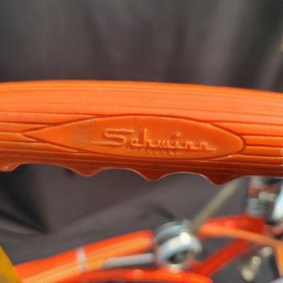 Sale Photo Thumbnail #10: Schwinn Sting-Ray Orange Krate with 5-speed Stik-Shift, springer front fork, high-rise handlebars, orange glitter grips, tall sissy bar, 1990's reproduction schwinn krate banana seat, original white letter slik rear tire, rear reflector, a PAIR of Schwinn