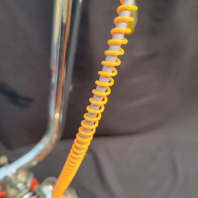 Sale Photo Thumbnail #9: Schwinn Sting-Ray Orange Krate with 5-speed Stik-Shift, springer front fork, high-rise handlebars, orange glitter grips, tall sissy bar, 1990's reproduction schwinn krate banana seat, original white letter slik rear tire, rear reflector, a PAIR of Schwinn