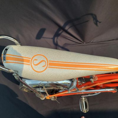 Sale Photo Thumbnail #7: Schwinn Sting-Ray Orange Krate with 5-speed Stik-Shift, springer front fork, high-rise handlebars, orange glitter grips, tall sissy bar, 1990's reproduction schwinn krate banana seat, original white letter slik rear tire, rear reflector, a PAIR of Schwinn