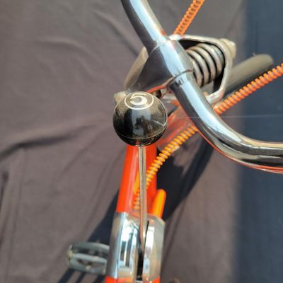 Sale Photo Thumbnail #8: Schwinn Sting-Ray Orange Krate with 5-speed Stik-Shift, springer front fork, high-rise handlebars, orange glitter grips, tall sissy bar, 1990's reproduction schwinn krate banana seat, original white letter slik rear tire, rear reflector, a PAIR of Schwinn