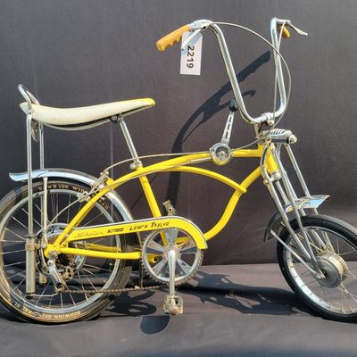 Sale Photo Thumbnail #18: Yellow Schwinn Sting-Ray Lemon Peeler Krate with 5-speed Stik-Shift, springer fork, Wide Tread rear tire, tall sissy bar,1990's reproduction yellow-and-white glitter banana seat, yellow grips and rear reflector. Attractive older frame repaint and decals, 