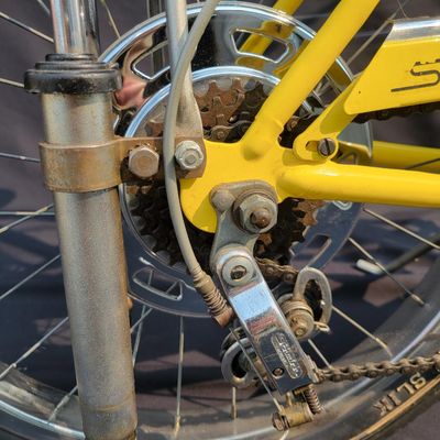 Sale Photo Thumbnail #26: Yellow Schwinn Sting-Ray Lemon Peeler Krate with 5-speed Stik-Shift, springer fork, Wide Tread rear tire, tall sissy bar,1990's reproduction yellow-and-white glitter banana seat, yellow grips and rear reflector. Attractive older frame repaint and decals, 