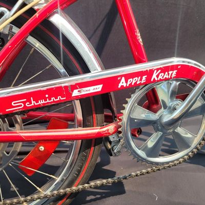 Sale Photo Thumbnail #29: Red Schwinn Sting-Ray Apple Krate with 5-speed Stik-Shift, springer front end, high-rise bars, red grips, tall sissy bar, striped banana seat, front drum-style hub and rear redline slik tire. Complete, well-presented example with normal vintage wear inclu