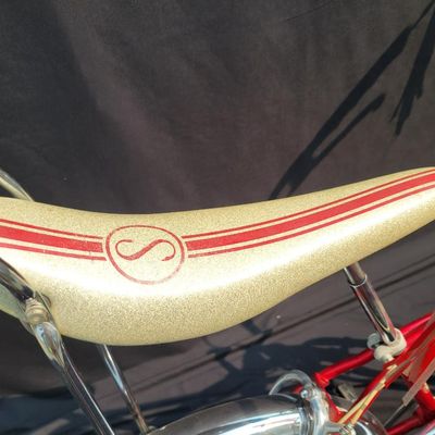 Sale Photo Thumbnail #32: Red Schwinn Sting-Ray Apple Krate with 5-speed Stik-Shift, springer front end, high-rise bars, red grips, tall sissy bar, striped banana seat, front drum-style hub and rear redline slik tire. Complete, well-presented example with normal vintage wear inclu