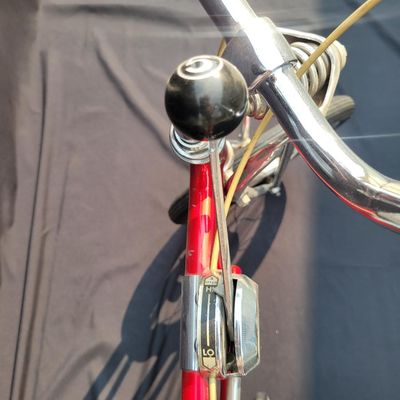 Sale Photo Thumbnail #34: Red Schwinn Sting-Ray Apple Krate with 5-speed Stik-Shift, springer front end, high-rise bars, red grips, tall sissy bar, striped banana seat, front drum-style hub and rear redline slik tire. Complete, well-presented example with normal vintage wear inclu