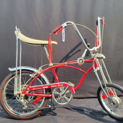 Sale Photo Thumbnail #28: Red Schwinn Sting-Ray Apple Krate with 5-speed Stik-Shift, springer front end, high-rise bars, red grips, tall sissy bar, striped banana seat, front drum-style hub and rear redline slik tire. Complete, well-presented example with normal vintage wear inclu