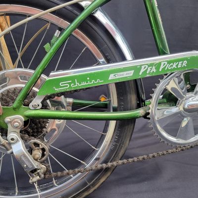 Sale Photo Thumbnail #41: Original Campus Green Schwinn Sting-Ray Pea Picker Krate with 5-speed Stik-Shift, springer fork, green banana seat and grips, tall sissy bar, Schwinn Sting-Ray speedometer/cyclometer and front lighting/reflector accessories. Also fitted with fun display a