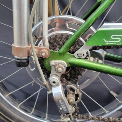 Sale Photo Thumbnail #42: Original Campus Green Schwinn Sting-Ray Pea Picker Krate with 5-speed Stik-Shift, springer fork, green banana seat and grips, tall sissy bar, Schwinn Sting-Ray speedometer/cyclometer and front lighting/reflector accessories. Also fitted with fun display a