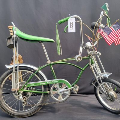 Sale Photo Thumbnail #40: Original Campus Green Schwinn Sting-Ray Pea Picker Krate with 5-speed Stik-Shift, springer fork, green banana seat and grips, tall sissy bar, Schwinn Sting-Ray speedometer/cyclometer and front lighting/reflector accessories. Also fitted with fun display a