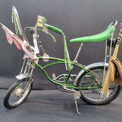 Sale Photo Thumbnail #56: Original Campus Green Schwinn Sting-Ray Pea Picker Krate with 5-speed Stik-Shift, springer fork, green banana seat and grips, tall sissy bar, Schwinn Sting-Ray speedometer/cyclometer and front lighting/reflector accessories. Also fitted with fun display a