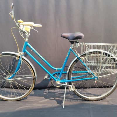 Sale Photo Thumbnail #83: Blue Schwinn Breeze women's 3-speed with full fenders, chainguard, oversized rear/side wire baskets, speedometer, bell, front reflector panel and rear reflector. The black saddle is a later replacement. Complete utility-style bicycle with plenty of vintag