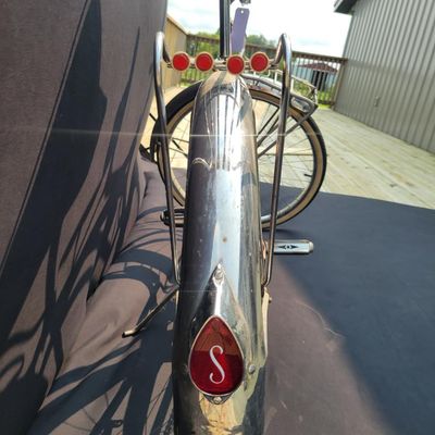 Sale Photo Thumbnail #98: Red Schwinn Corvette loaded with period-style accessories including whitewall tires, full chrome fenders, front and rear carriers, chrome tank insert, red Mesinger-style saddle, bell, headlight, twin front reflectors and cyclometer/control accessories. Ve