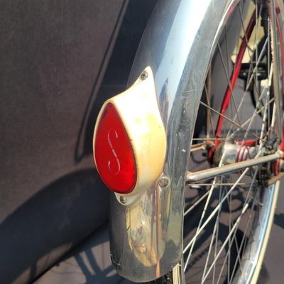 Sale Photo Thumbnail #118: Red Schwinn Jaguar with whitewall tires, full fenders, rear carrier, tank-style frame insert, red Mesinger-style saddle, bell, front light equipment and Jaguar-marked chainguard. The rear wheel sports a Bendix Red Band 2 speed Automatic Hub.  A nicely equ