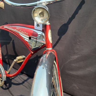 Sale Photo Thumbnail #115: Red Schwinn Jaguar with whitewall tires, full fenders, rear carrier, tank-style frame insert, red Mesinger-style saddle, bell, front light equipment and Jaguar-marked chainguard. The rear wheel sports a Bendix Red Band 2 speed Automatic Hub.  A nicely equ