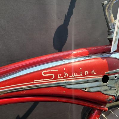 Sale Photo Thumbnail #114: Red Schwinn Jaguar with whitewall tires, full fenders, rear carrier, tank-style frame insert, red Mesinger-style saddle, bell, front light equipment and Jaguar-marked chainguard. The rear wheel sports a Bendix Red Band 2 speed Automatic Hub.  A nicely equ