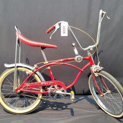 Sale Photo Thumbnail #132: Red Schwinn Deluxe Sting-Ray 3-speed with Deluxe Sting-Ray chainguard, high-rise handlebars, banana saddle, whhitewall Schwinn tires,  sissy bar, front fender and period internal-gear equipment. Honest unrestored condition with paint chips, decal wear, ch