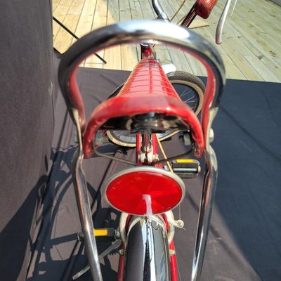 Sale Photo Thumbnail #137: Red Schwinn Deluxe Sting-Ray 3-speed with Deluxe Sting-Ray chainguard, high-rise handlebars, banana saddle, whhitewall Schwinn tires,  sissy bar, front fender and period internal-gear equipment. Honest unrestored condition with paint chips, decal wear, ch