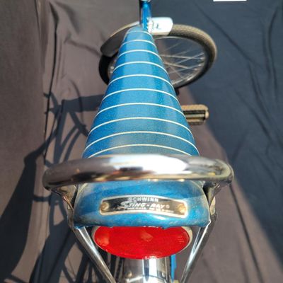Sale Photo Thumbnail #145: Blue Schwinn Deluxe Sting-Ray single speed coaster brake bicycle with blue banana seat, tall sissy bar, blue grips, high-rise handlebars, fenders and rear reflector. Very complete, original paint and attractive with moderate vintage wear to the saddle, gr
