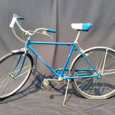 Sale Photo Thumbnail #155: Blue Schwinn Racer men's 3-speed with internal-gear hub, full fenders, blue/white saddle, blue grips and rear reflector. Complete vintage commuter showing normal saddle wear, chrome patina and age to the tires and hardware. Clean, classic Schwinn styling 