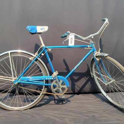 Sale Photo Thumbnail #147: Blue Schwinn Racer men's 3-speed with internal-gear hub, full fenders, blue/white saddle, blue grips and rear reflector. Complete vintage commuter showing normal saddle wear, chrome patina and age to the tires and hardware. Clean, classic Schwinn styling 