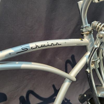 Sale Photo Thumbnail #159: 2004-era Schwinn Grey Ghost Sting-Ray factory reproduction, not an original 1971 Grey Ghost. Finished in silver/gray with chrome springer fork, 16-inch front and 20-inch rear wheels, Wald Ramshorn Handlebars,  Wide Tread rear tire, chrome fenders, striped