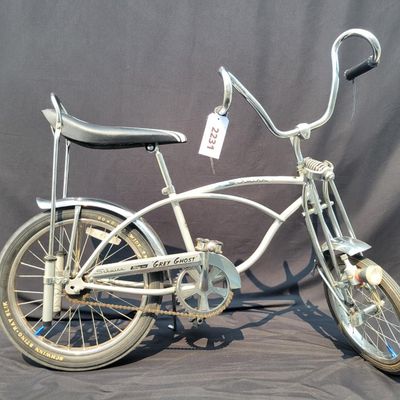 Sale Photo Thumbnail #156: 2004-era Schwinn Grey Ghost Sting-Ray factory reproduction, not an original 1971 Grey Ghost. Finished in silver/gray with chrome springer fork, 16-inch front and 20-inch rear wheels, Wald Ramshorn Handlebars,  Wide Tread rear tire, chrome fenders, striped
