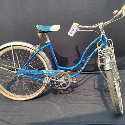 Sale Photo Thumbnail #175: Blue/teal Schwinn Fair Lady 3-speed with whitewall tires, full fenders, front rack, blue/white saddle, cream grips and bell. Complete and attractive vintage step-through bike with plenty of period style. Shows age to the saddle, chrome, spokes and tires a
