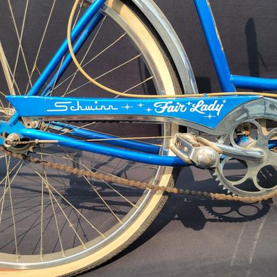 Sale Photo Thumbnail #176: Blue/teal Schwinn Fair Lady 3-speed with whitewall tires, full fenders, front rack, blue/white saddle, cream grips and bell. Complete and attractive vintage step-through bike with plenty of period style. Shows age to the saddle, chrome, spokes and tires a